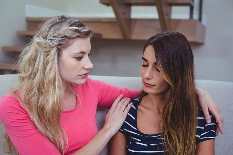 woman comforting woman