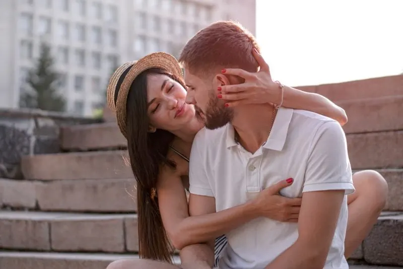 woman hugging man and smiling