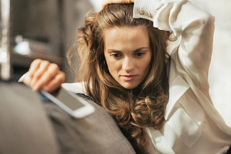 young anxious woman sitting on the couch