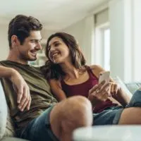 couple sitting on sofa at home