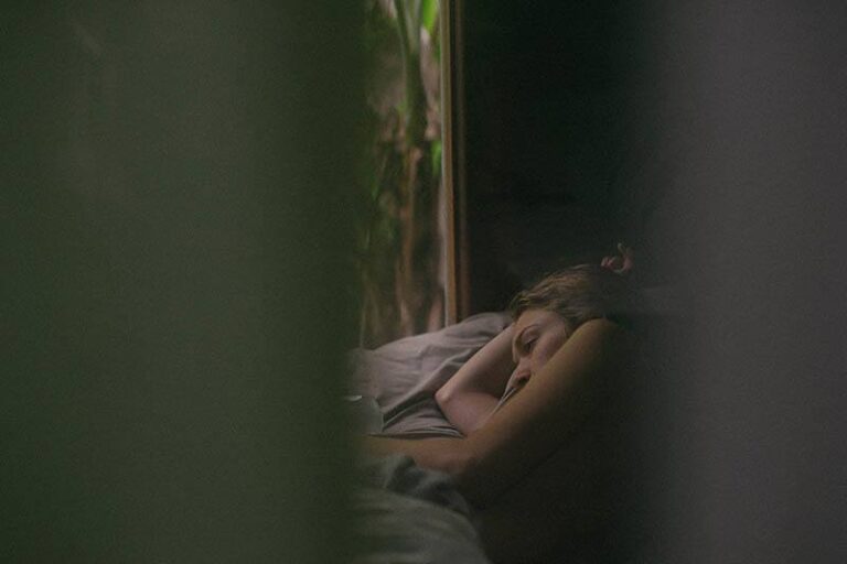 thoughtful woman lying on bed