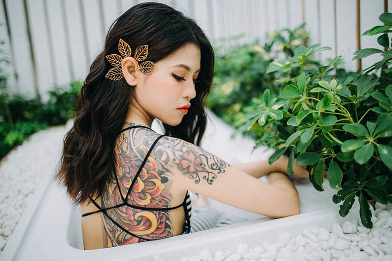 asian woman with tattoo posing