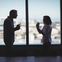 man arguing with woman in office