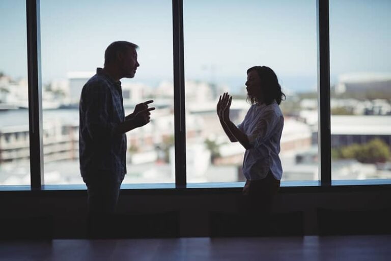 man arguing with woman in office