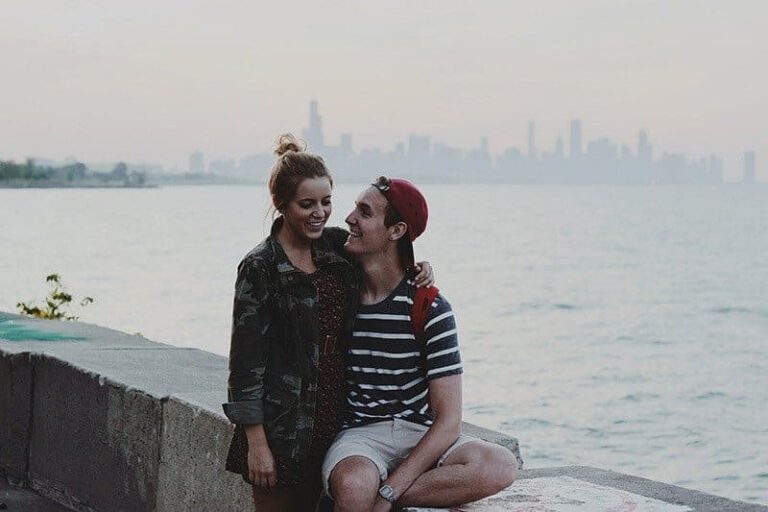 smiling couple hugging by the sea