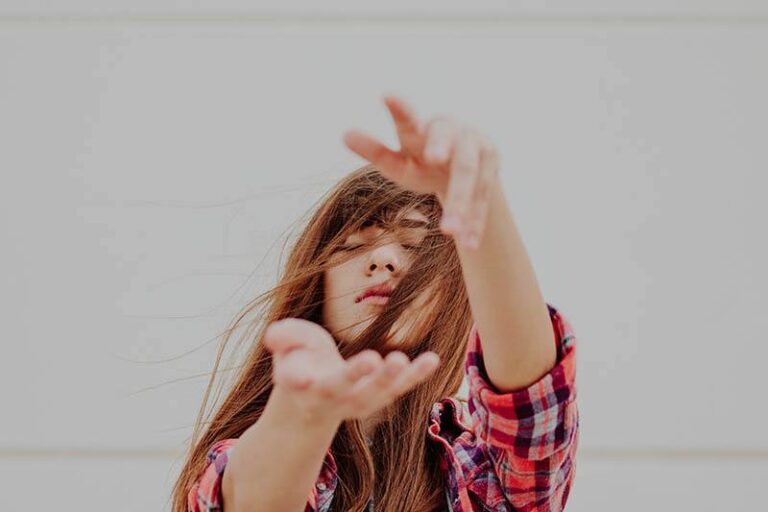 woman with closed eyes outside