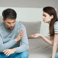 couple arguing on the bed