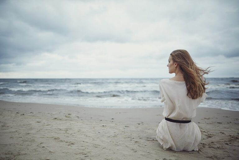 lonely woman sitting on the beach