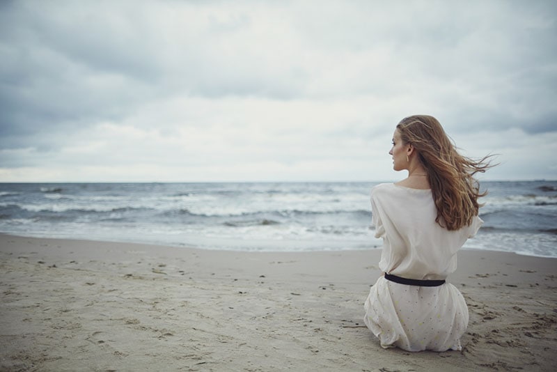 lonely woman sitting on the beach