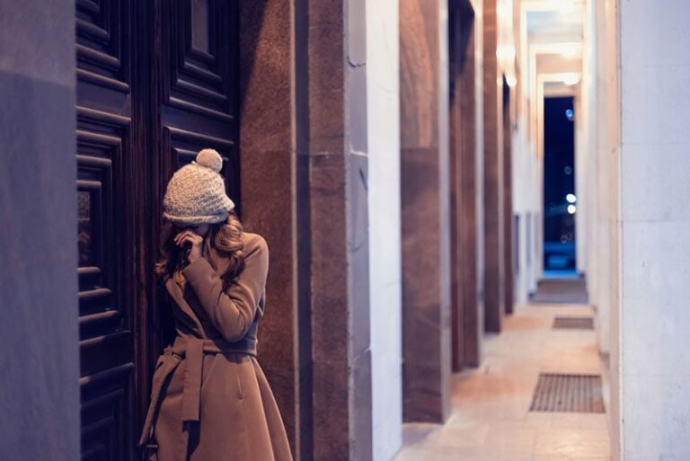 sad woman standing outdoor on the cold