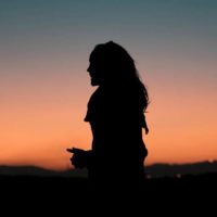 silhouette of woman standing outside