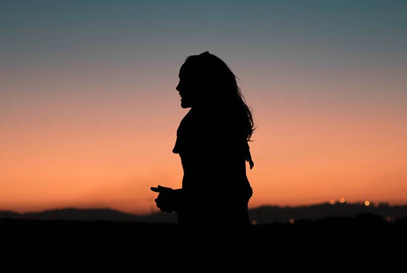 silhouette of woman standing outside