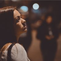 sad woman standing on the street