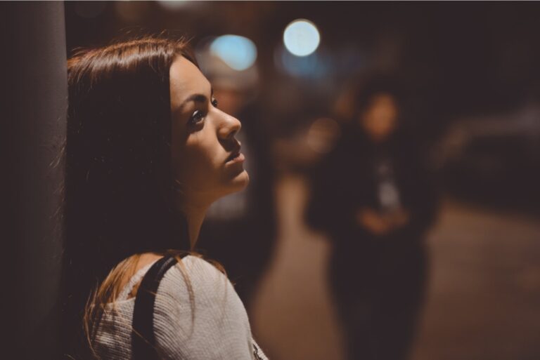 sad woman standing on the street