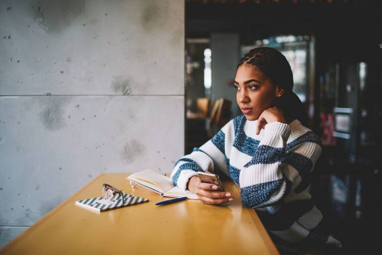 thoughtful woman in cafe bar