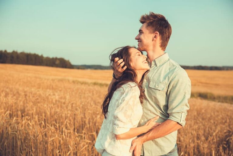 outdoor portrait of young stylish fashion couple posing in summer