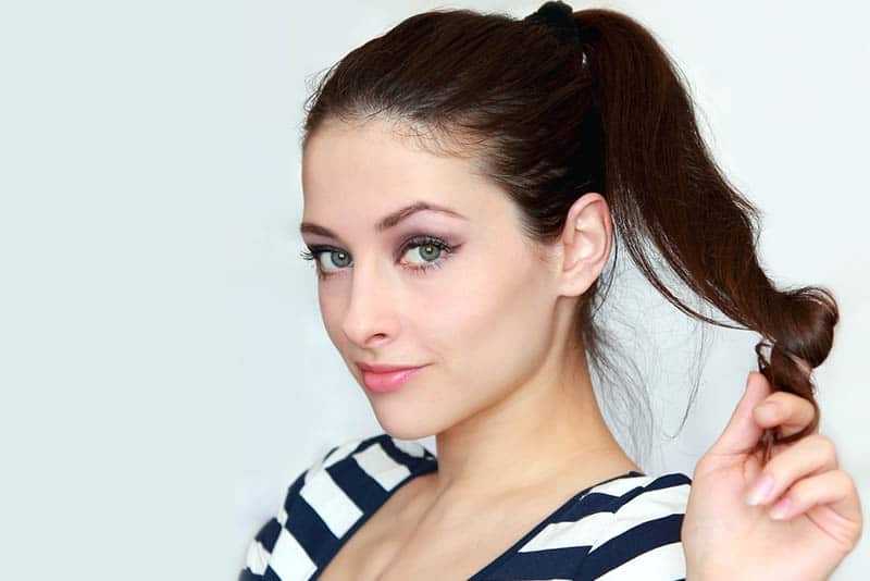 close up photo of woman playing with her hair