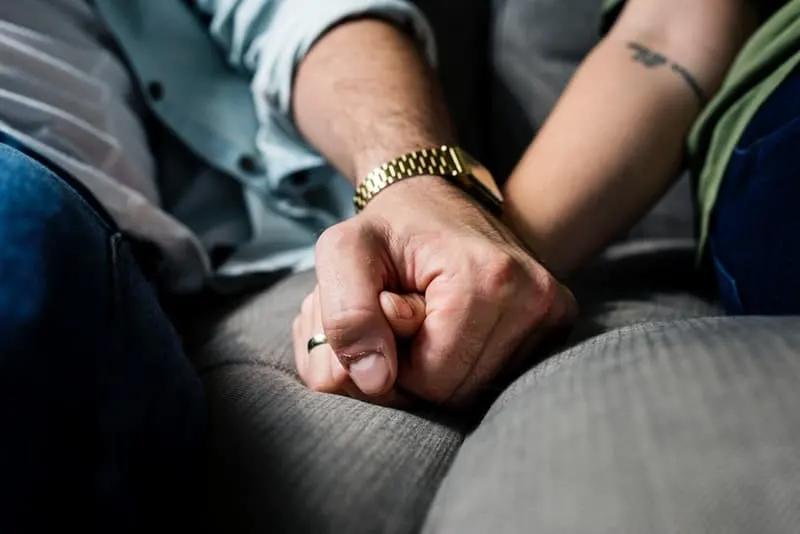 closeup photo of man holding woman hand in the car