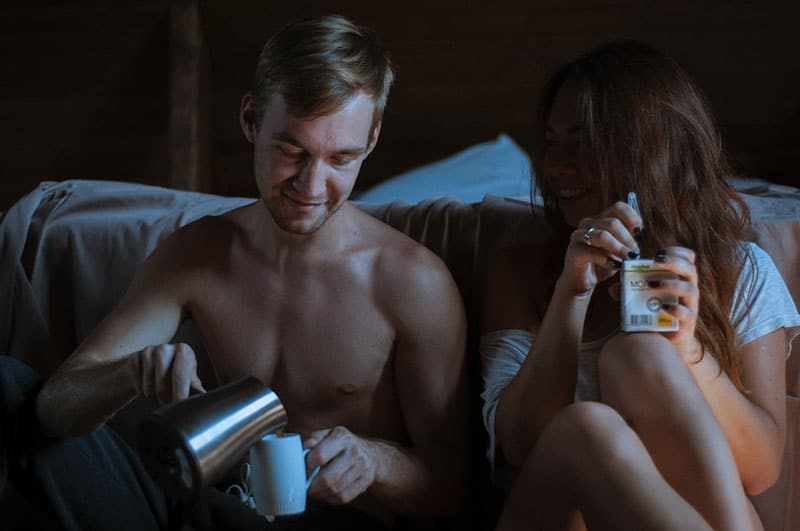couple drinking coffee in the bedroom