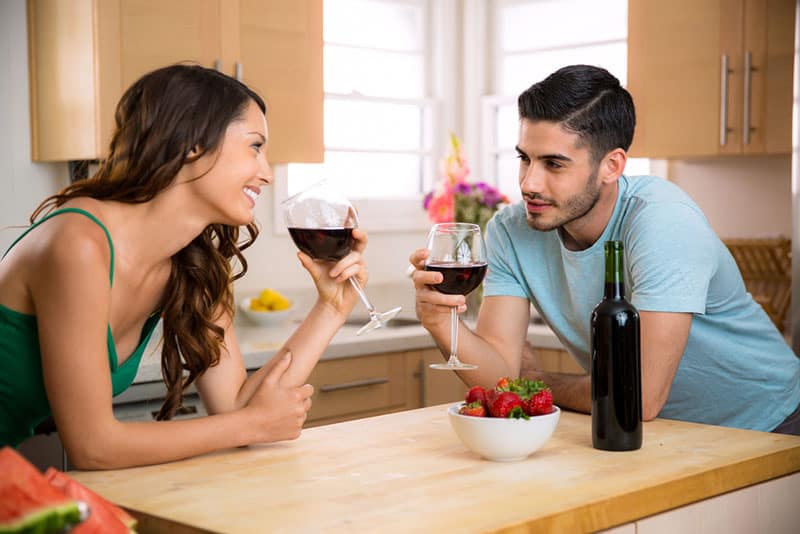 couple flirting and drinking wine