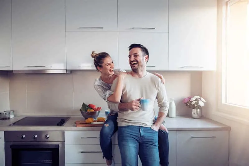 couple laughing in the kitchen