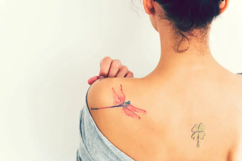 dragonfly tattoo on womans shoulder