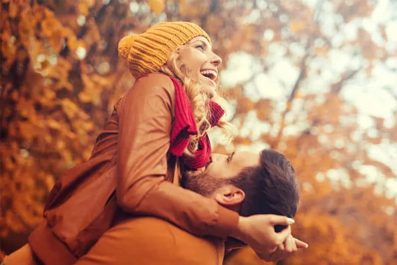 happy man pickup woman during autumn