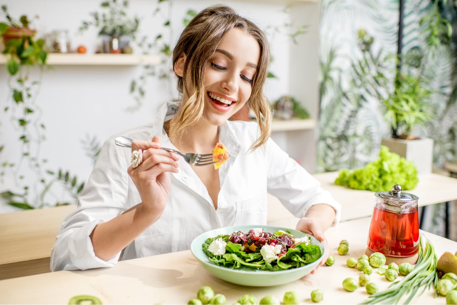 happy woman eating a salad