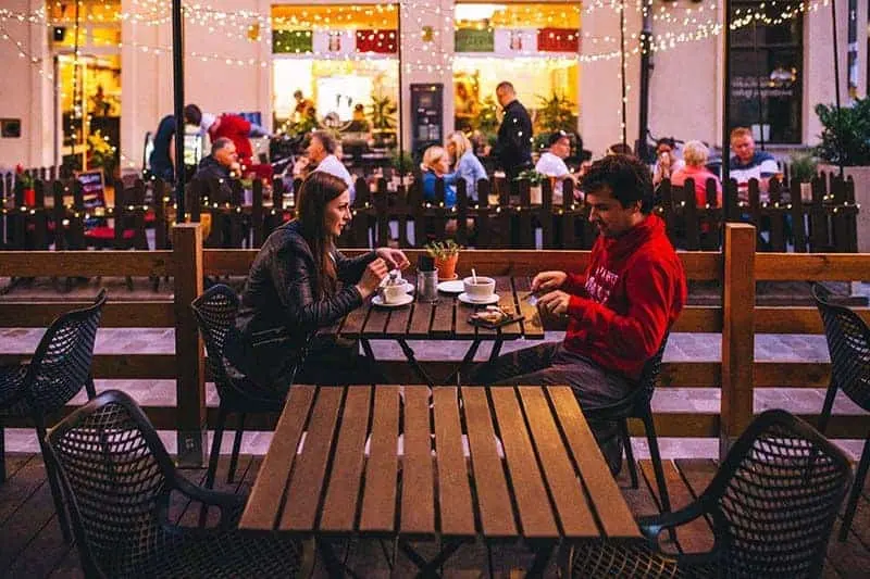 man and woman eating in restaurant