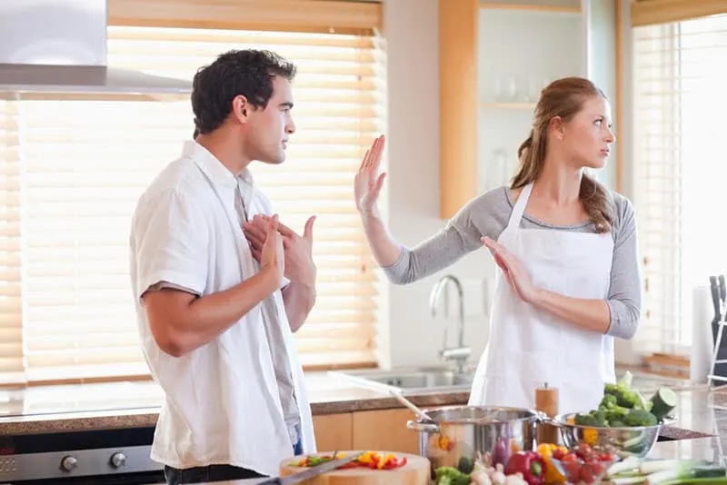man arguing with wife in the kitchen