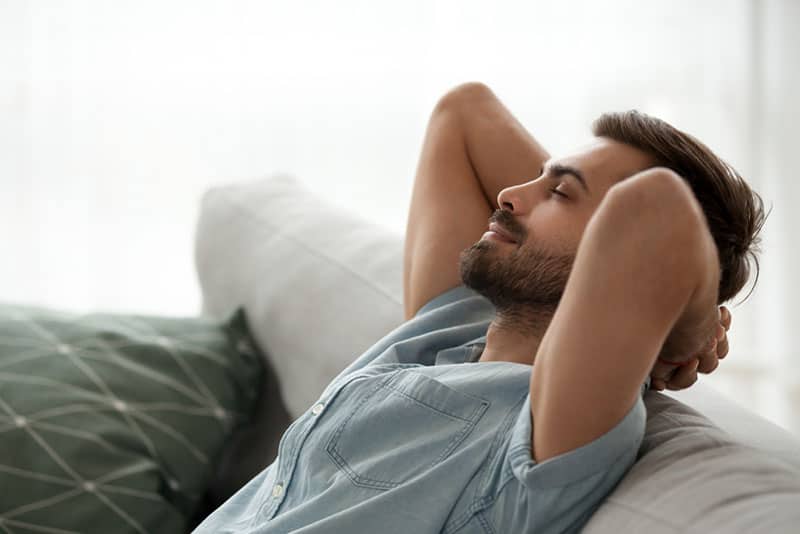 man relaxing on couch