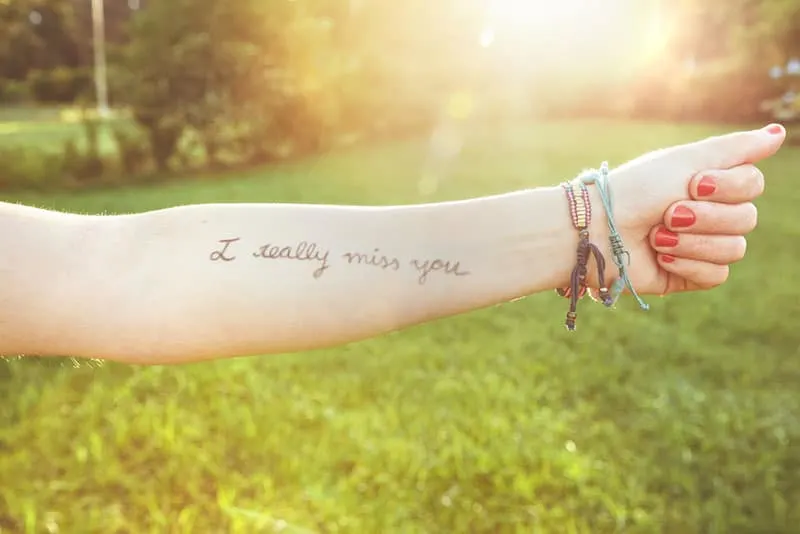 quote tattoo about missing someone on the hand