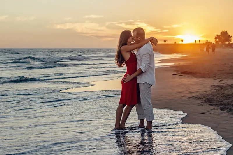 romantic couple kissing on the beach