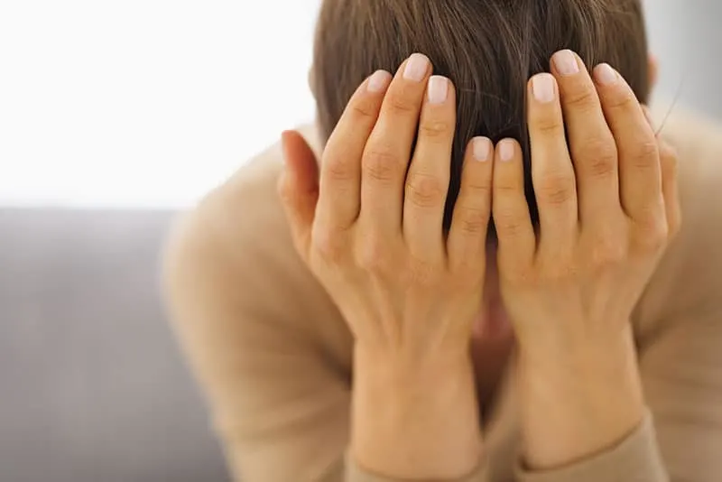 sad woman holding hands on the face