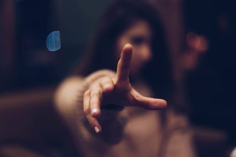 shallow focus of woman pointing with finger