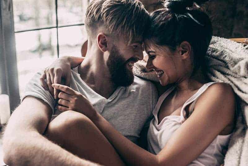 smiling couple sitting at home