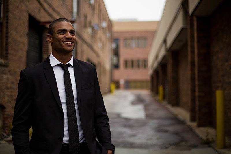 smiling man in suits on street