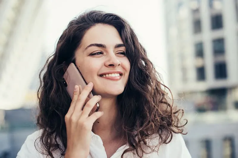smiling woman talking on the phone