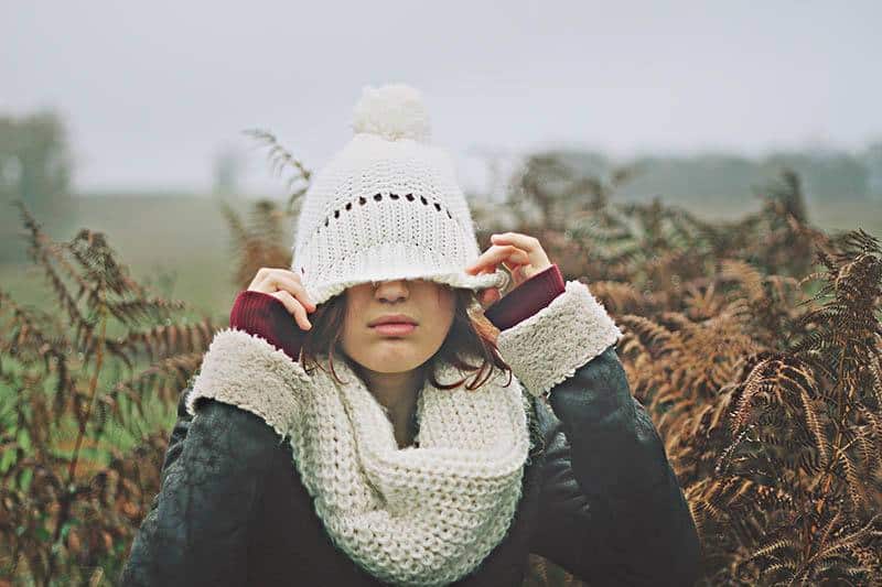 woman lowered her hat over her eyes