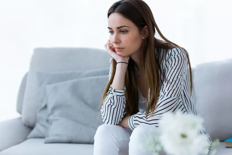 worried woman sitting in the living room