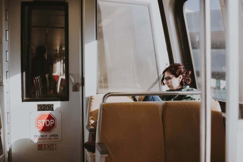 worried woman sitting in train