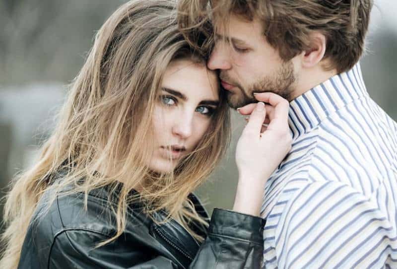 young man and woman standing outside