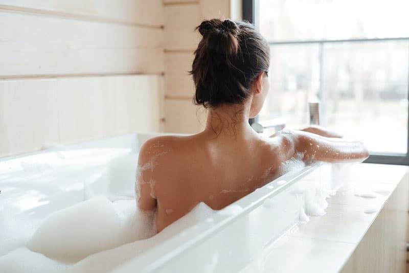 young woman having a bubble bath