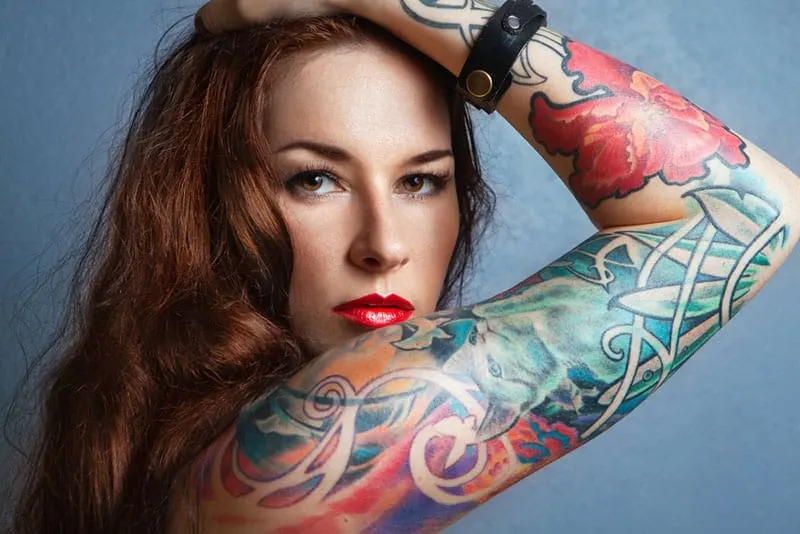 young woman posing with tattoo on arm