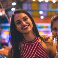 female friends smiling on camera