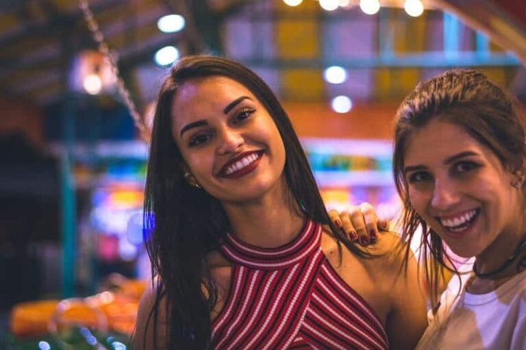female friends smiling on camera