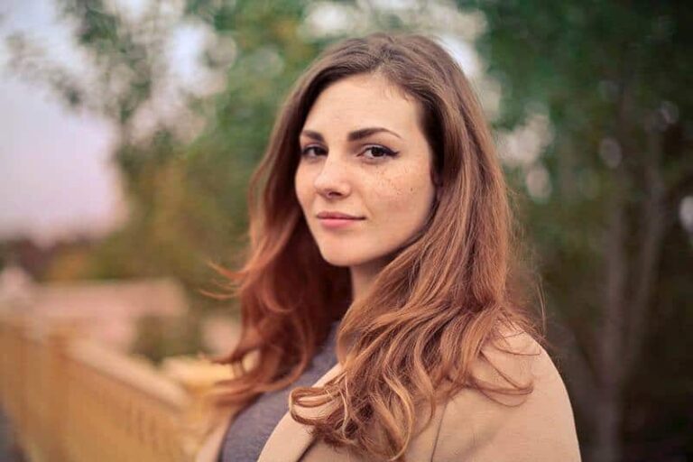 portrait of brunette woman standing outside