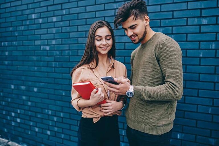 a young man and a girl outside talking