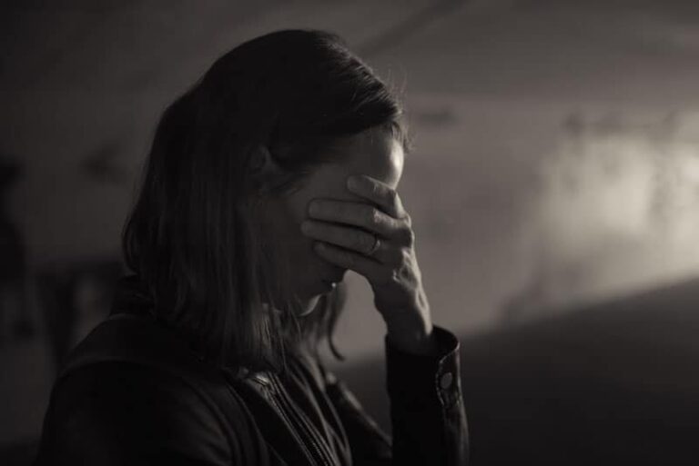 depressed woman sitting in the dark