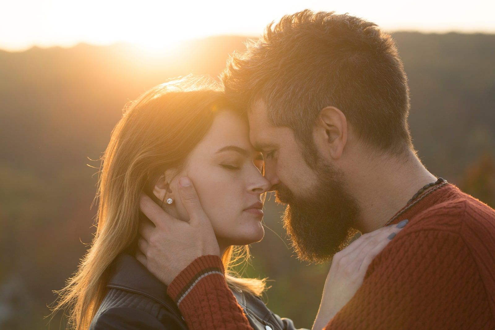 Couple with pensive faces standing close to each other